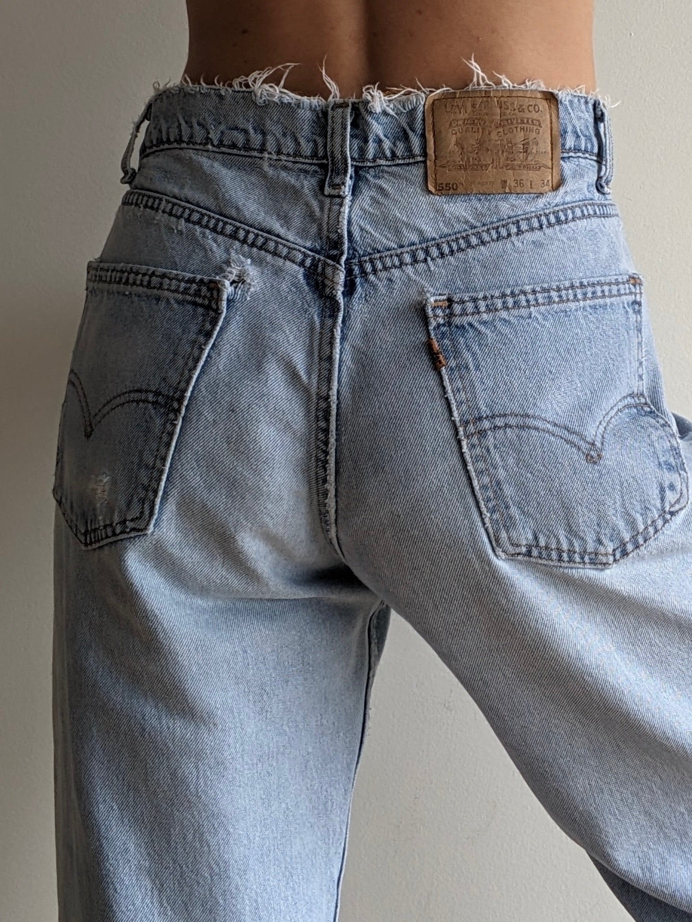 Vintage Levi's Distressed 550 Orange Tab Jeans